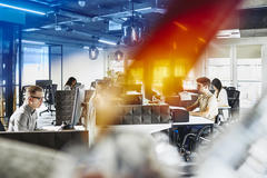 Group of people working behind their computers at their cubicles at the office. Focused.