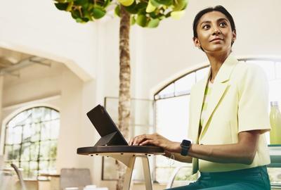 woman working on a tablet, looking up to her left